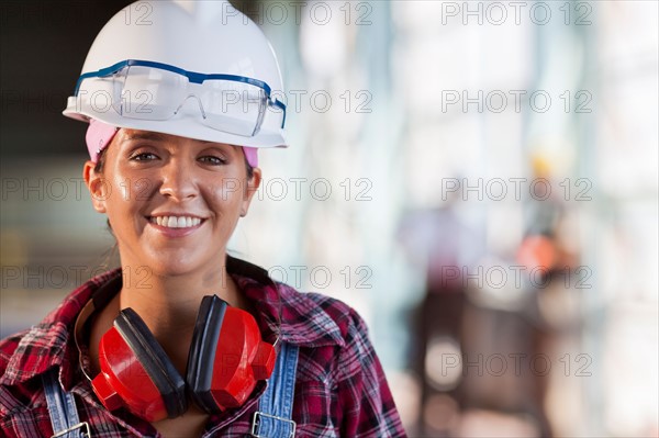 Portrait of female manual worker wearing hardhat. Photo: db2stock