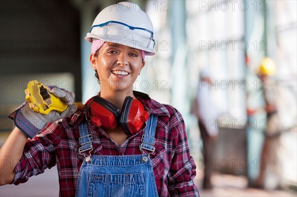 Portrait of female manual worker wearing hardhat. Photo: db2stock