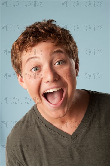 Studio portrait of boy (12-13) looking surprised. Photo: Rob Lewine