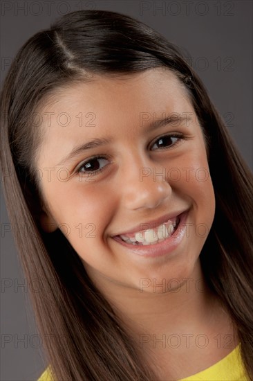 Portrait of smiling girl (8-9), studio shot. Photo : Rob Lewine