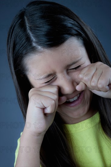 Studio portrait of girl (8-9) crying. Photo : Rob Lewine