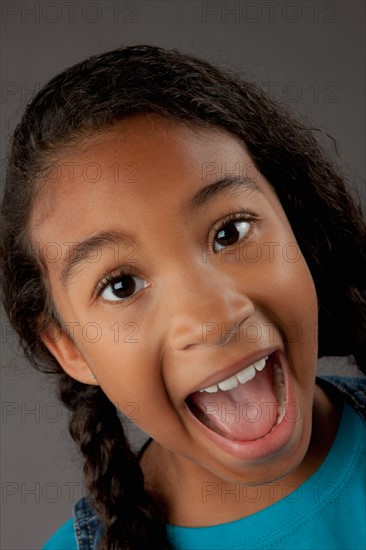 Studio portrait of girl (8-9) shouting. Photo : Rob Lewine