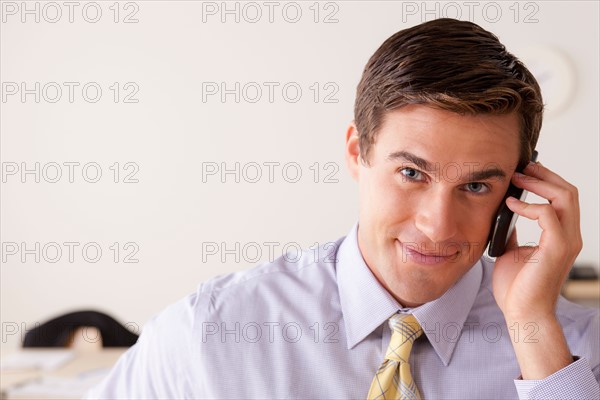 Portrait of businessman talking on phone. Photo : Rob Lewine