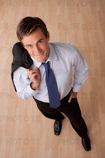 Portrait of young smiling businessman in office. Photo: Rob Lewine