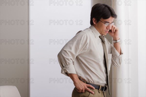 Young businessman using cell phone. Photo : Rob Lewine