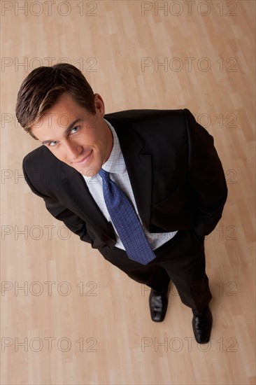 Portrait of young businessman smiling. Photo : Rob Lewine