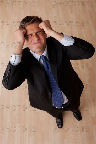 Portrait of young frustrated businessman . Photo : Rob Lewine