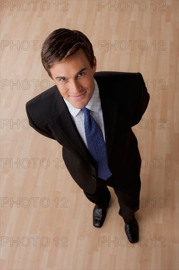 Portrait of young businessman smiling. Photo : Rob Lewine