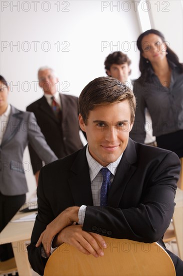 Business people in office looking at camera. Photo : Rob Lewine