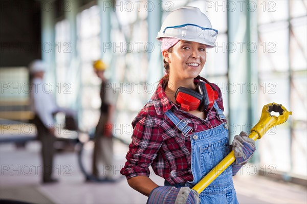 Portrait of female manual worker wearing hardhat. Photo : db2stock