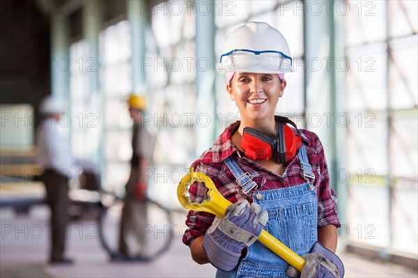 Portrait of female manual worker wearing hardhat. Photo: db2stock