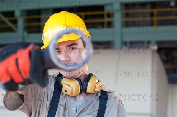 Portrait of male manual worker holding tool. Photo : db2stock