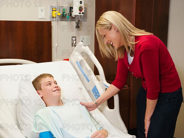 Mother visiting son (10-11) in hospital.