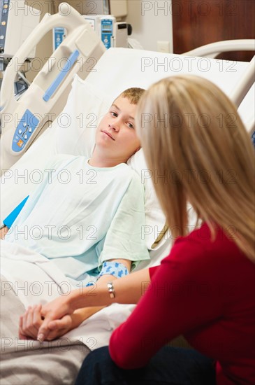 Mother visiting son (10-11) in hospital.