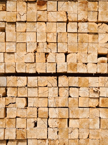 Full-frame shot of orderly timber stacks.