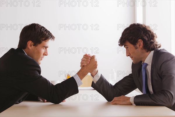 Two business men armwrestling. Photo : Rob Lewine