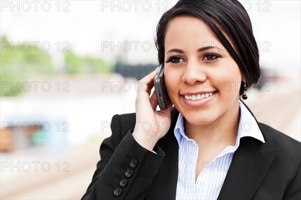 Young businesswoman talking on phone. Photo: Take A Pix Media