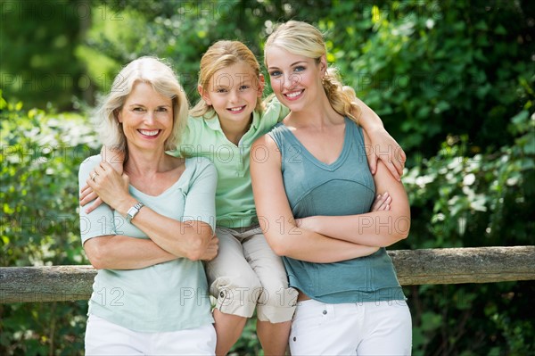 Portrait of girl (10-11) with mother and grandmother.