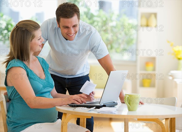 Young couple using laptop.
