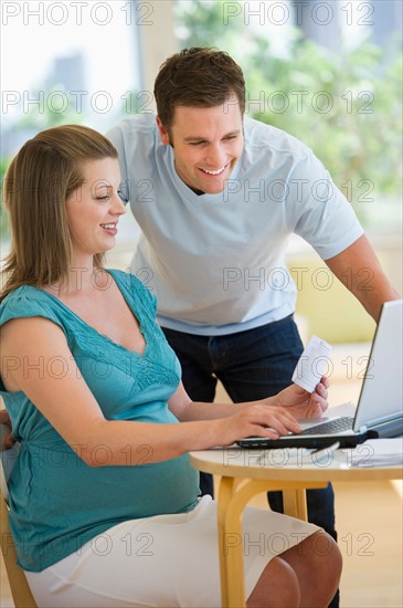 Young couple using laptop.