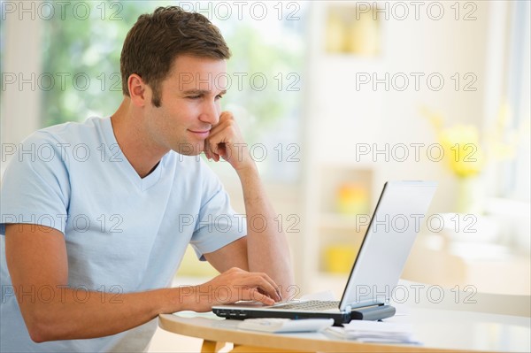 Young man using laptop.