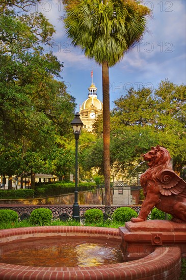 USA, Georgia, Savannah, Fountain in park with dome of City Hall in background.