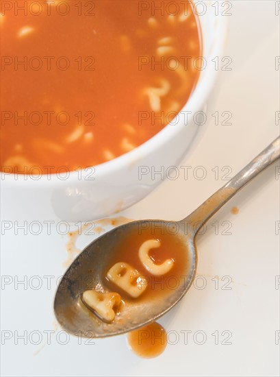 Close up of soup with letter noodles on spoon . Photo : Jamie Grill