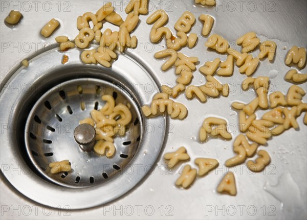 Close up of letter noodles in kitchen sink. Photo : Jamie Grill