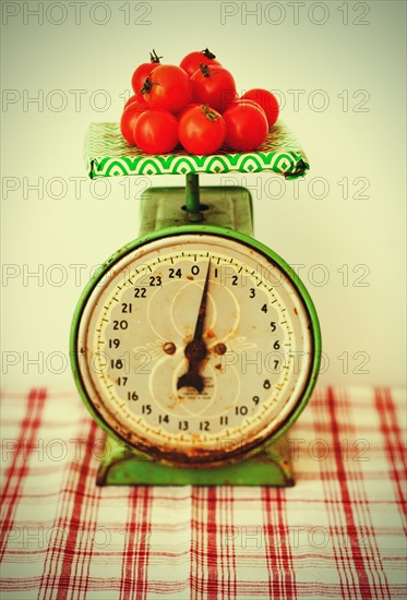 Studio shot of tomatoes on scales.