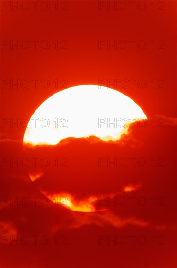 Close-up of large red sun.