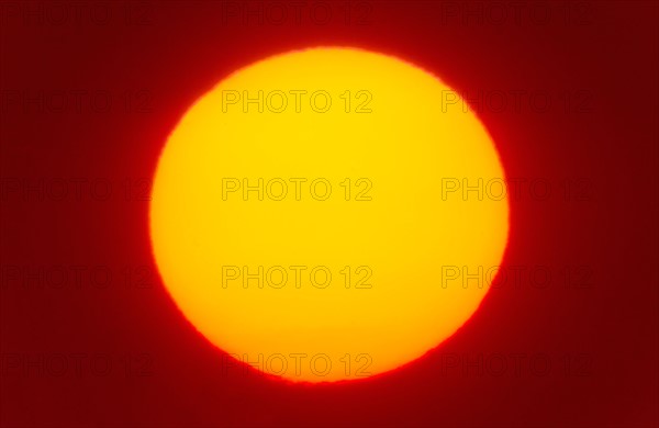 Close-up of large red sun.