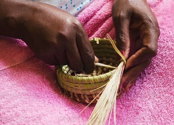 USA, South Carolina, Charleston, Hands of worker weaving sweetgrass.