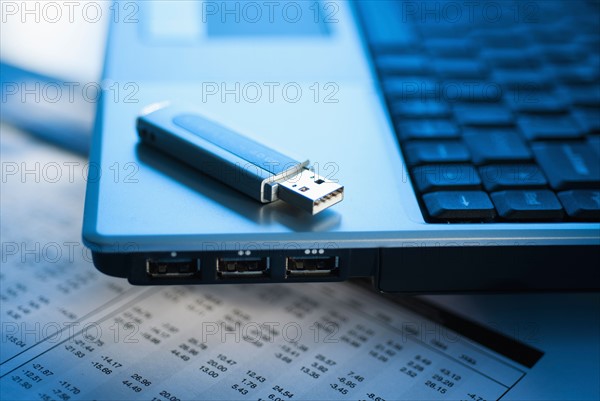 Studio shot of laptop with memory stick.