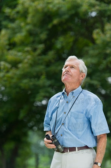 Senior man with binoculars.