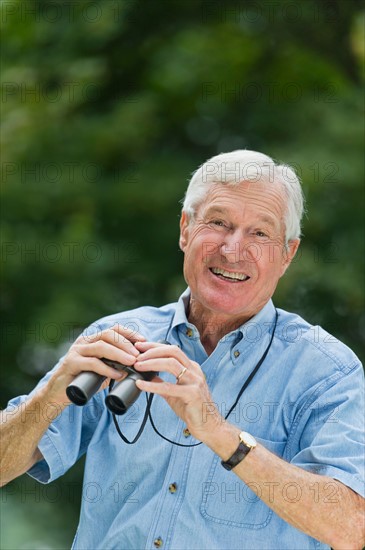 Senior man with binoculars.