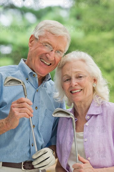 Senior couple playing golf.