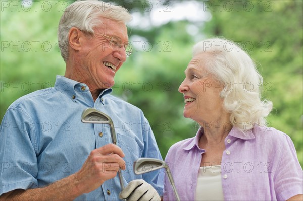 Senior couple playing golf.