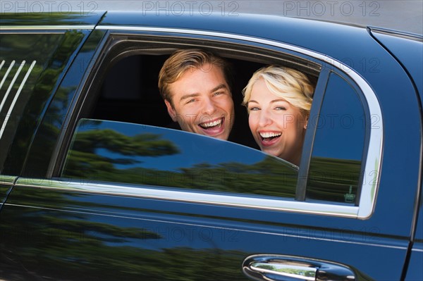 Happy married couple in limousine.