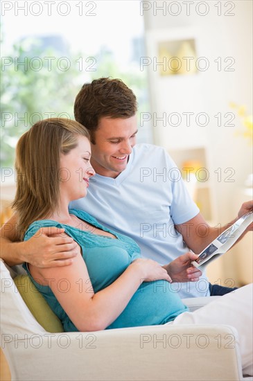 Happy parents watching ultrasound picture of baby.