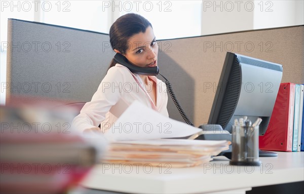 Businesswoman working at desk in office. Photo: Jamie Grill