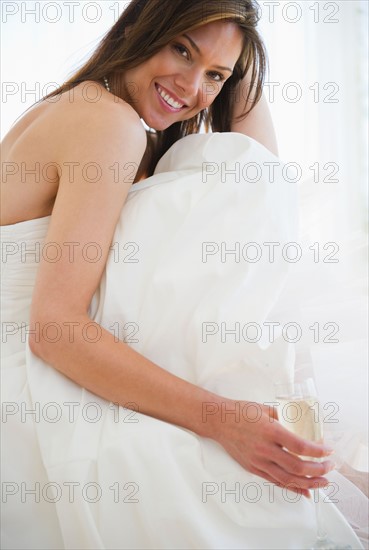 Portrait of smiling woman in wedding dress. Photo : Jamie Grill