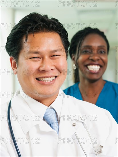 Doctor and nurse posing for portrait.