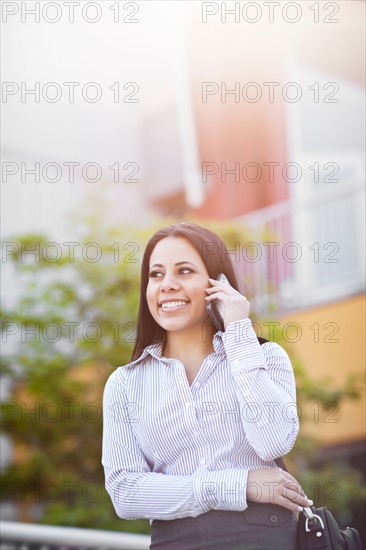 Young businesswoman talking on phone. Photo: Take A Pix Media