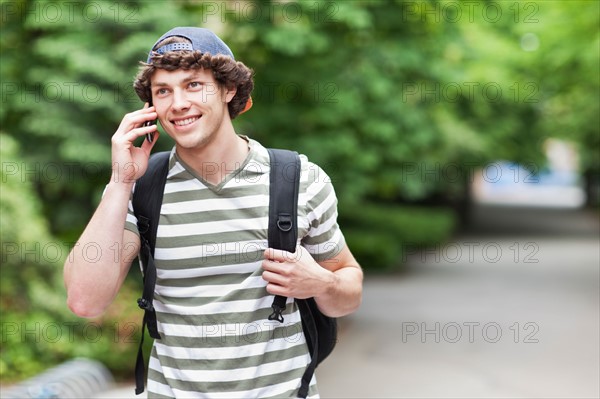 Male college student talking on cell phone. Photo: Take A Pix Media