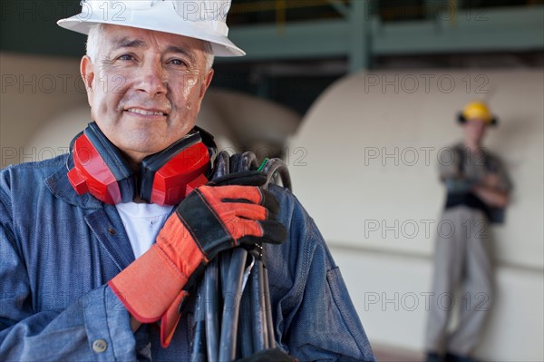 Portrait of male manual worker wearing hardhat. Photo : db2stock