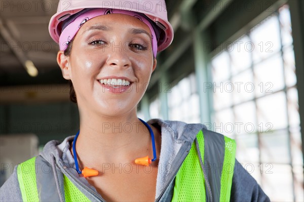 Portrait of female manual worker wearing hardhat. Photo : db2stock