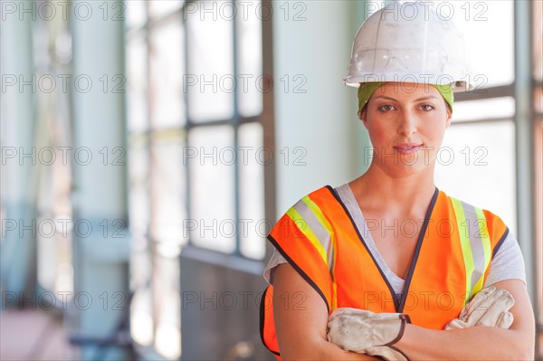 Portrait of female manual worker wearing hardhat. Photo : db2stock