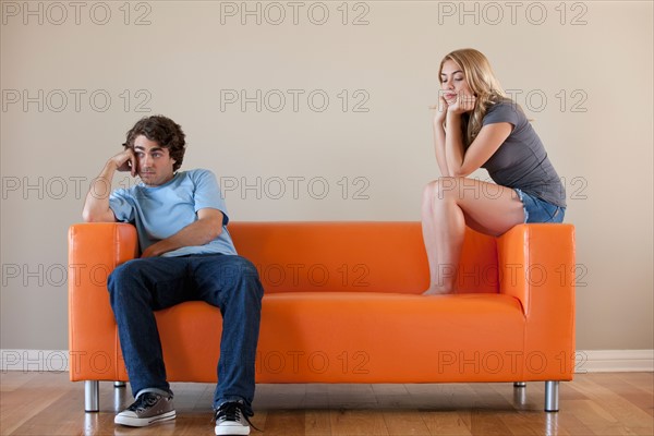 Young couple sitting on sofa. Photo : Rob Lewine