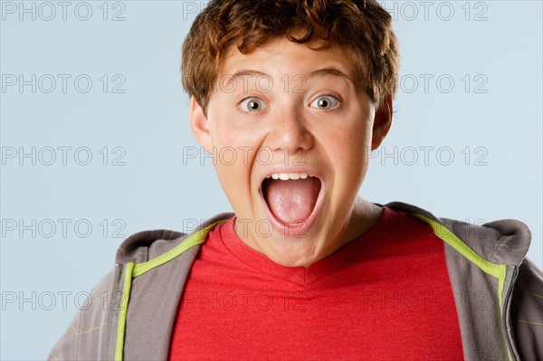 Studio portrait of boy (12-13) looking surprised. Photo : Rob Lewine