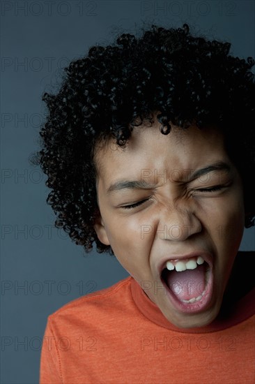 Studio portrait of boy (8-9) screaming. Photo : Rob Lewine